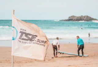 Surf teacher and student preparing for lesson